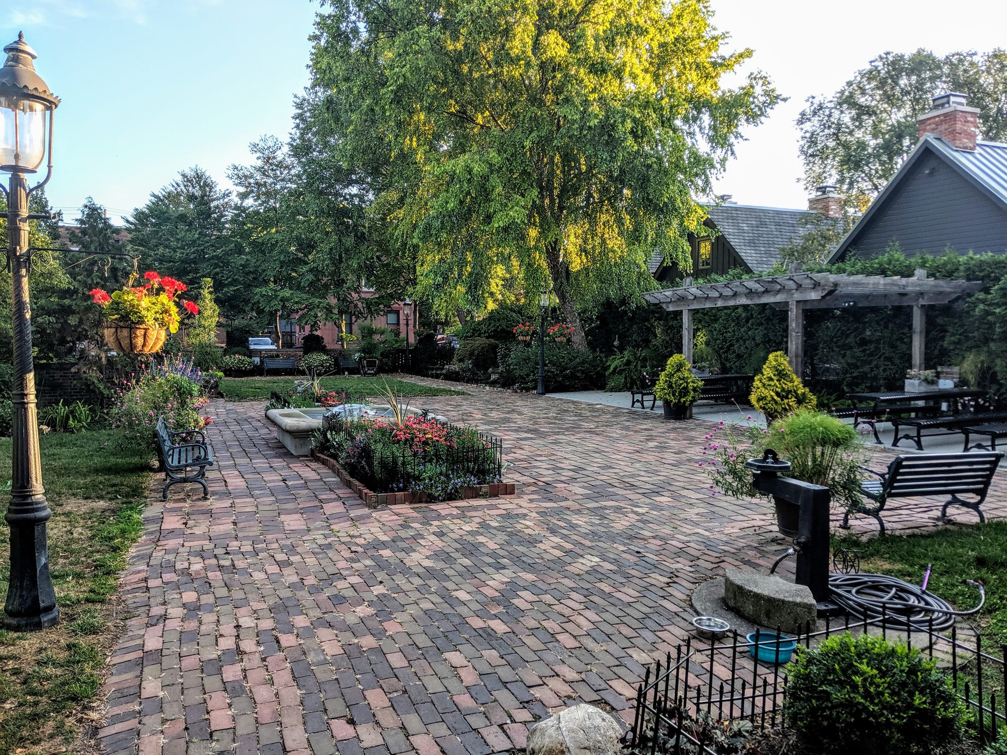 Brick path winding through dense flower gardens at Frank Fetch Park